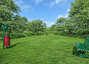 Thumbnail 2 of 14 - Park area with green bench and landscaping at Grand Gateway Apartments, Minnesota, 56301
