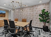 Thumbnail 3 of 14 - Modern conference room with wooden table at Grand Gateway Apartments, St Cloud, Minnesota