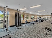 Thumbnail 8 of 14 - Spacious fitness center with cardio and strength equipment at Grand Gateway Apartments, Minnesota
