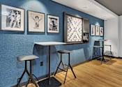 Thumbnail 6 of 14 - Community cafe seating with gallery wall art at Grand Gateway Apartments, Minnesota, 56301