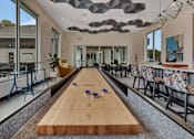 Thumbnail 5 of 40 - Shuffleboard table in modern resident game room at Prosper West Apartments, Waite Park, Minnesota
