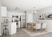 Thumbnail 35 of 40 - Modern kitchen with white cabinetry and dining space at Prosper West Apartments, Minnesota, 56387