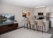 Thumbnail 19 of 25 - Open concept living area with kitchen island and bar seating at Regency Park Apartments, St Cloud, MN