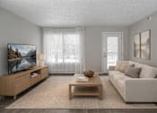 Thumbnail 18 of 25 - Living room with modern furniture and patio door at Regency Park Apartments, St Cloud