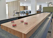 Thumbnail 2 of 25 - Shuffleboard table in resident game room at Regency Park Apartments, St Cloud, Minnesota