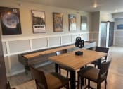 Thumbnail 51 of 56 - a dining room with a table and chairs and pictures on the wall