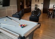 Thumbnail 50 of 56 - a living room with a pool table and chairs