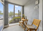Thumbnail 20 of 23 - a porch with two wooden chairs and a small table and a window