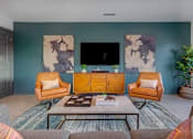 Thumbnail 4 of 10 - Modern living room with blue accent wall at Creekview Apartments, Midvale, UT 84047