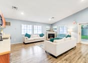 Thumbnail 8 of 13 - a living room with couches and a fireplace
