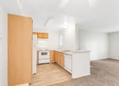Thumbnail 2 of 13 - a kitchen with white appliances and wooden cabinets