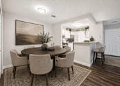 Thumbnail 17 of 21 - Dining area with round table and upholstered chairs at Northview Park Apartments, Sterling Heights, MI
