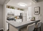 Thumbnail 15 of 21 - Modern kitchen with breakfast bar seating at Northview Park Apartments, Sterling Heights, MI 48310