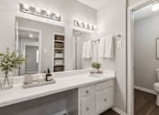 Thumbnail 13 of 13 - Bathroom with white vanity and mirror at Stratford Arms Apartments, Riverdale, Georgia