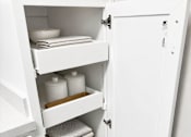 Thumbnail 12 of 12 - A white kitchen pantry with a door open.