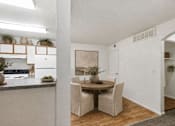 Thumbnail 9 of 16 - A dining area with a table and chairs.