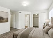 Thumbnail 14 of 16 - A bedroom with a large bed and a painting on the wall at Slate Canyon Apartments, Provo, UT, 84606