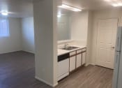 Thumbnail 3 of 13 - an empty kitchen with white cabinets and a sink