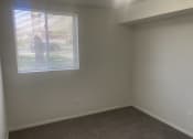 Thumbnail 5 of 13 - an empty room with a window and a carpet