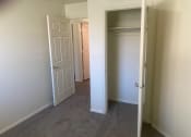 Thumbnail 6 of 13 - a bedroom with a closet and an open door