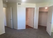 Thumbnail 4 of 13 - an empty room with three doors and a carpeted floor