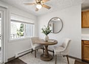 Thumbnail 10 of 10 - A dining room with a table and chairs.