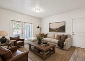 Thumbnail 15 of 33 - Living room with beige sofa and brown leather chairs at Silver Ridge Apartments, Idaho, 83642