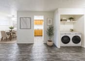 Thumbnail 13 of 17 - A modern laundry room with a washer and dryer.
