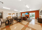 Thumbnail 10 of 12 - A large room with a checkered floor and a long table with chairs.