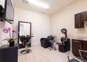 Thumbnail 8 of 26 - A room with a black chair and a black cabinet.