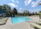 Thumbnail 24 of 24 - A large outdoor swimming pool surrounded by sun loungers.