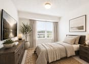 Thumbnail 3 of 5 - Cozy bedroom with natural light and neutral tones at Lakewood Apartments, Minnesota, 55014