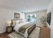 Thumbnail 3 of 22 - A bedroom with a large bed and a window overlooking a street.