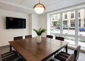 Thumbnail 16 of 36 - A conference room with a large table and chairs.