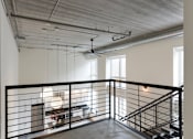 Thumbnail 32 of 36 - A large open space with a staircase and a balcony.