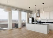 Thumbnail 26 of 36 - A modern kitchen with a large island and a view of the city.