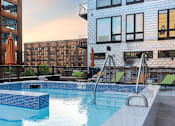 Thumbnail 21 of 43 - A swimming pool with a blue tiled edge and a metal ladder.