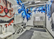 Thumbnail 34 of 43 - A room with a mural of a tiger on the wall and a table in the middle.