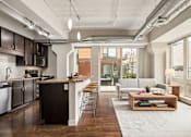 Thumbnail 5 of 43 - A modern kitchen with dark wood floors and a large island.