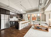 Thumbnail 7 of 43 - A modern kitchen with dark wood cabinets and stainless steel appliances.
