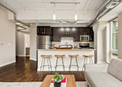 Thumbnail 9 of 43 - A kitchen with dark brown cabinets and a white countertop.