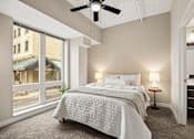 Thumbnail 13 of 43 - A bedroom with a large bed and a ceiling fan.