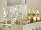 Thumbnail 34 of 40 - A bottle of Belvedere vodka is on a counter with glasses and bottles of Fever tree tonic water.