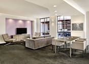Thumbnail 17 of 40 - A modern living room with a grey carpet and a purple wall.