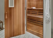 Thumbnail 19 of 40 - A wooden door with a white handle and a towel hanging on the wall.