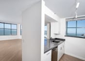 Thumbnail 3 of 95 - A kitchen with a large island and a view of the water.