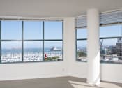 Thumbnail 4 of 95 - A white column stands in a room with two windows overlooking a marina.