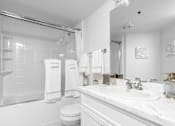 Thumbnail 17 of 95 - A white bathroom with a toilet, sink, and shower.