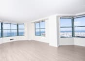 Thumbnail 61 of 95 - A room with a large window overlooking a cityscape.