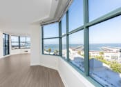 Thumbnail 63 of 95 - A room with a view of the ocean through large windows.